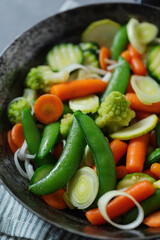 Vegan vegetables on pan on table