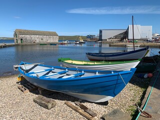 Fototapeta na wymiar Rowing Boat in Lerwick Harbour on Shetland