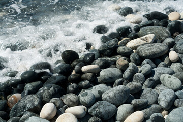 Wet and dry stones on the beach