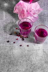 pink alcoholic drink in glass shot glasses
