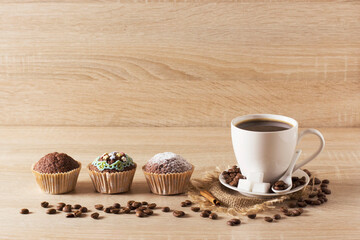 Muffins and a cup of coffee on a light background