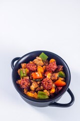 Extremadura crumbs, breadcrumbs, sausage, bacon, red and green peppers, garlic and paprika. Concept of traditional home cooking. Vertical photo and selective focus