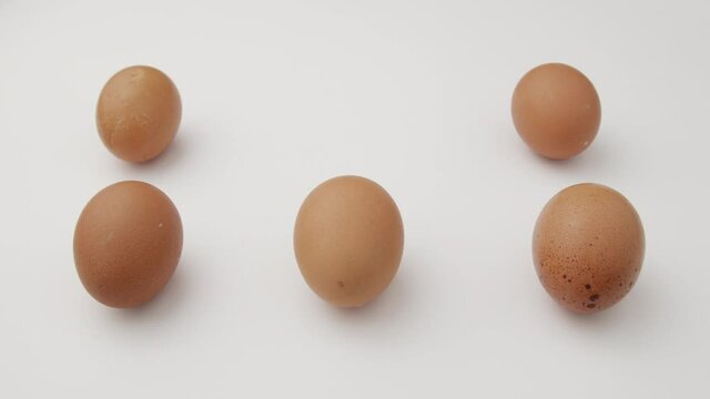 Creative flat lay pattern of Organic eggs&nbsp;on white background.
happy easter scene woman hand puts  egg on the white table pattern.