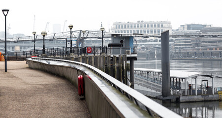 River Thames low tide. London in rain. Empty streets of London during national lockdown UK, 2021