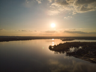 drone aerial photo of flight above the river at sunset time.