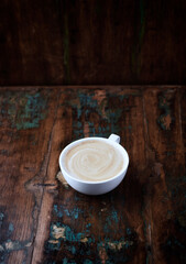 Cappuccino on dark wooden background. Copy space.