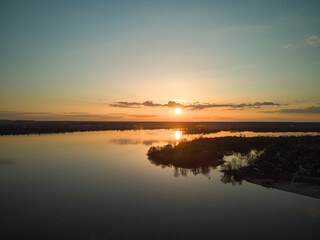 drone aerial photo of flight above the river at sunset time.