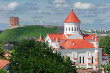 Obraz premium View of Vilnius Old Town in summer. In front - one of the oldest Christian shrines in the city - Cathedral of the Theotokos. In the distance - Gediminas Tower - the remaining part of the Upper Castle