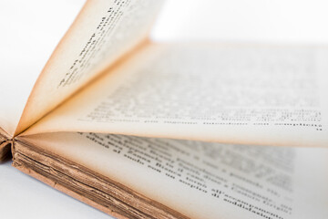 Antique open book isolated with flipping pages on white background