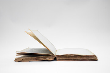 Antique open book isolated with flipping pages on white background