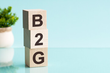 three wooden cubes with letters b2g - short for business to government, concept