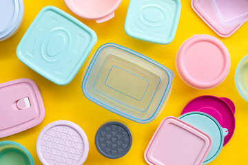 various containers for food storage on yellow background