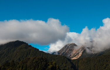 Landscape of mountains with blue sky and clouds over the hills