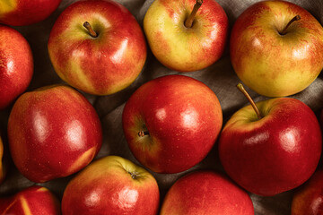 Sweet fresh ripe red apple harvest background.