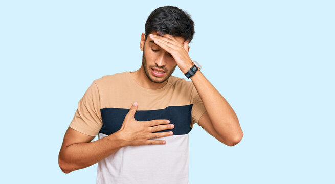 Young handsome man wearing casual clothes touching forehead for illness and fever, flu and cold, virus sick