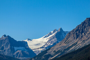 Snow capped mountains on sunny day with blue skies