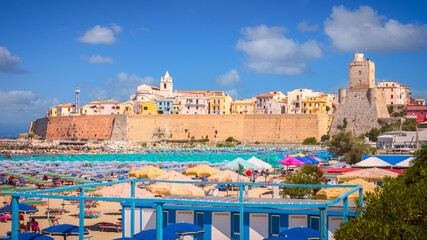 Panoramic view of the old town of Termoli with beach umbrellas, the colorful houses and Svevo Castle, Termoli, Italy