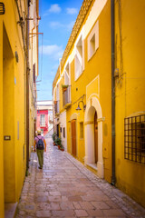 Fototapeta na wymiar Narrow pedestrian streets in the old town, with colorful houses and cobblestones, Termoli, Italy
