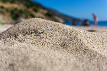 Sand puddle. view of people on the beach from the dune.