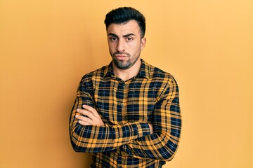 Young hispanic man wearing casual clothes skeptic and nervous, disapproving expression on face with...