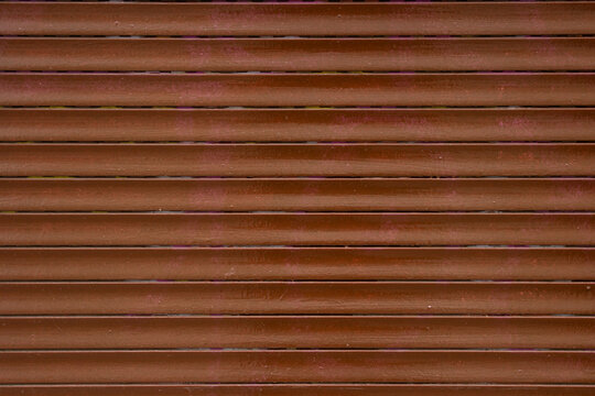 Old roller shutter rusty with brown paint background image 