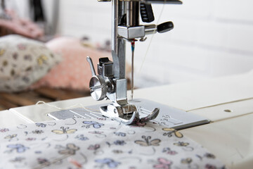 Sewing machine operation from different angles and sewing a flowered fabric. Selective Focus Machine part.
