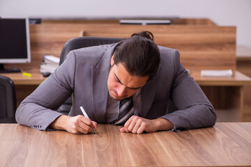 Young businessman employee sitting in the office