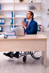 Young disabled employee working in the office