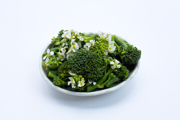 Green baby broccoli with chinese kale flower on white