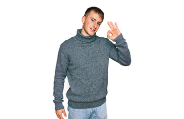 Young blond man wearing casual clothes smiling positive doing ok sign with hand and fingers. successful expression.