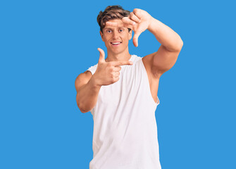 Naklejka premium Young handsome man wearing sleveeless t shirt smiling making frame with hands and fingers with happy face. creativity and photography concept.