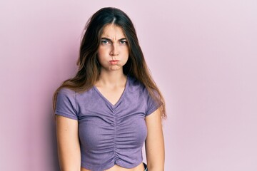 Obraz premium Young caucasian woman wearing casual clothes puffing cheeks with funny face. mouth inflated with air, crazy expression.