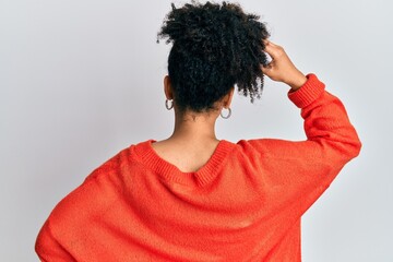 Young african american girl wearing casual clothes backwards thinking about doubt with hand on head