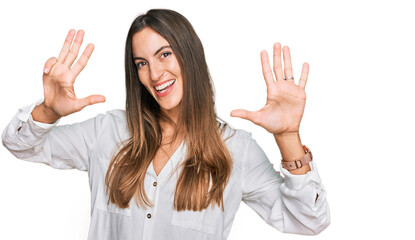 Young beautiful woman wearing casual clothes showing and pointing up with fingers number nine while...