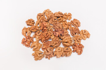 A bunch of peeled walnut brown halves on a white background, isolated