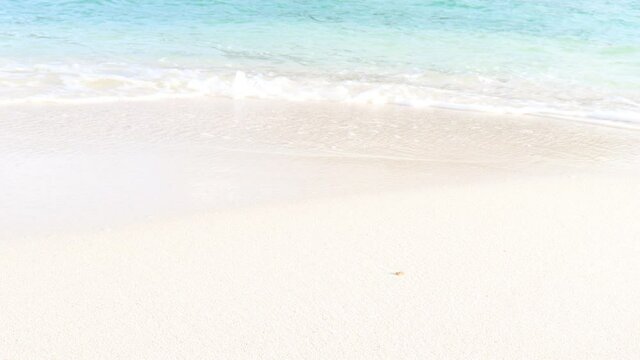 Ocean waves crashing on white sand beach, beautiful natural scene of tropical summer sea beach.