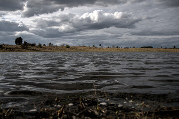 stormy sky, spring landscape, rough lake