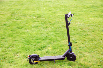 Electric scooter on green lawn. Electromobility in Germany 