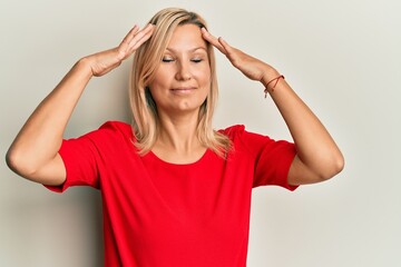 Middle age caucasian woman wearing casual clothes with hand on head, headache because stress. suffering migraine.