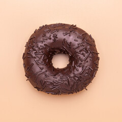 tasty chocolate doughnut isolated on brown background