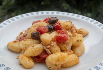 Gnocchi with cherry tomatoes, olives and fresh sea bream