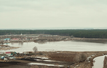 Flood waters cover the house and the field in the lawn. view from above. Flood after rains