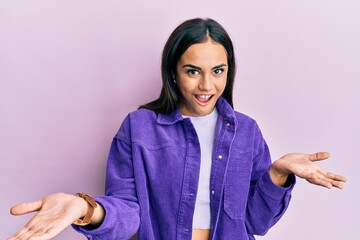 Young brunette woman wearing casual clothes smiling cheerful with open arms as friendly welcome, positive and confident greetings