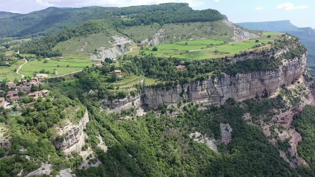 Scenic aerial view of small town of Tavertet located on edge of cliffs on summer day, Catalonia, Spain. High quality 4k footage
