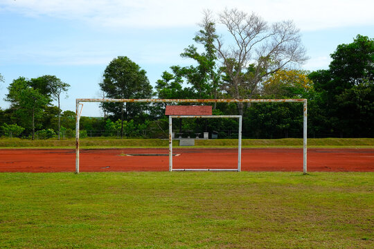 Selective focus picture of rusty goalpost still used in the football field that can cause hazard to player