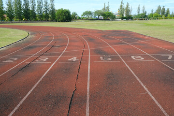 A picture of numbers on damage and ruin running track in the morning. No maintainance been done after the place been left 