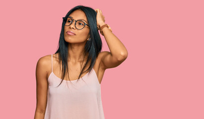 Young african american woman wearing casual clothes and glasses confuse and wondering about question. uncertain with doubt, thinking with hand on head. pensive concept.