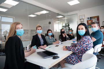real business people on meeting wearing protective mask