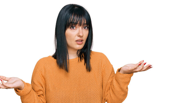 Young hispanic woman wearing casual clothes clueless and confused with open arms, no idea concept.