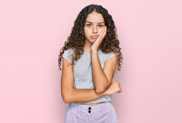 Teenager hispanic girl wearing casual clothes thinking looking tired and bored with depression problems with crossed arms.